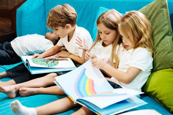 group-of-diverse-young-students-reading-children-s-PEXS9MS.jpg